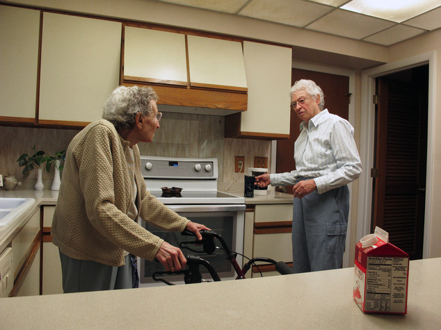 In this Friday, Aug. 1, 2014 photo, Lennie Gerber, right, hands a cup of coffee to her spouse, Pearl Berlin, in the kitchen of their High Point, N.C., home. Berlin is 89, and in fragile health, so their fight to overturn North Carolina's gay marriage ban has taken on an urgency. (AP Photo/Allen G. Breed)