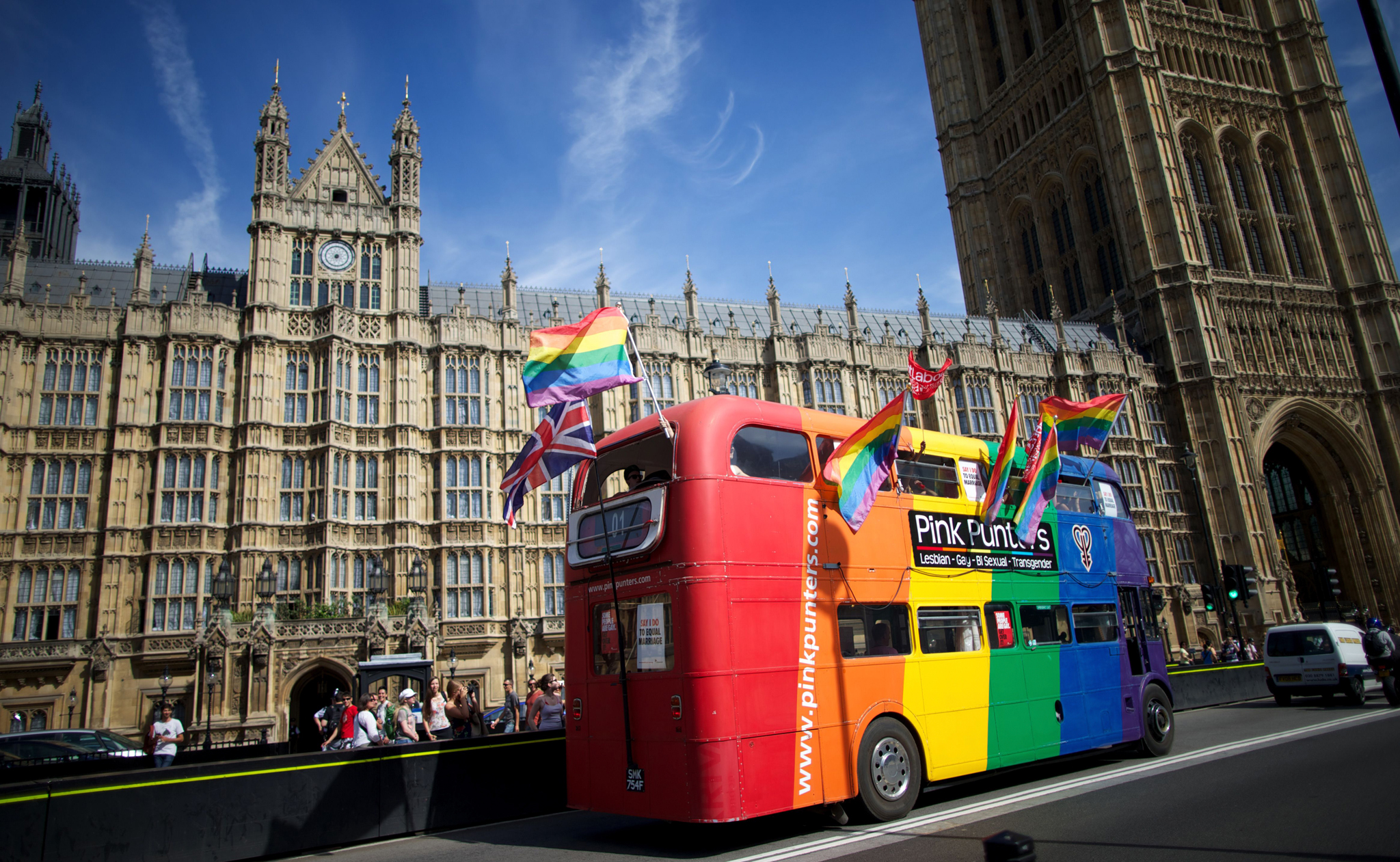 Gay campaigners drive a bus past the Hou