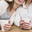close-up-lesbian-woman-s-hand-holding-cup-coffee-table