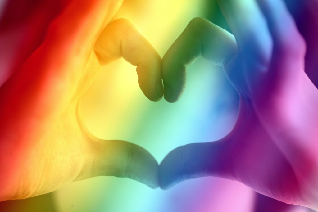 lgbtq+ colors with hands making the heart shape