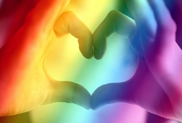 lgbtq+ colors with hands making the heart shape
