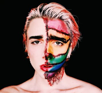 lgbtq+ person with half-painted face