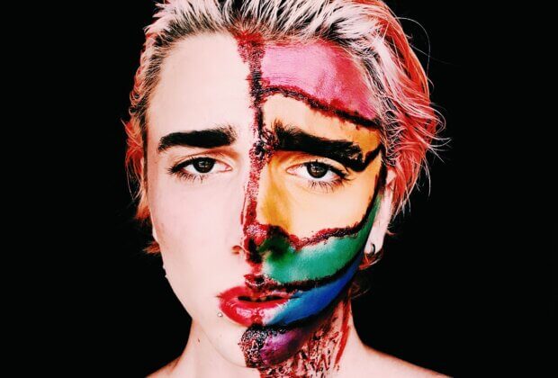 lgbtq+ person with half-painted face